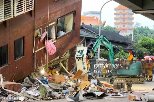 This frame grab from AFPTV video taken on April 3, 2024 shows rescue workers searching for survivors at the damaged Uranus Building in Hualien, after...