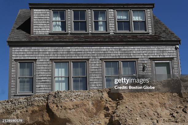 Nantucket, MA Curtains and shades are visible in the three bedroom home on Hummock Pond Rd. The home sits on the edge of an eroded dune and will have...