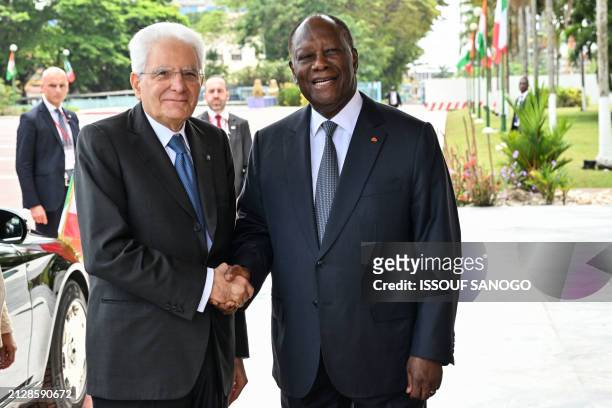 Italian President Sergio Mattarella is welcome by Ivorian President Alassane Ouattara at the president palace in Abidjan on April 3, 2024.