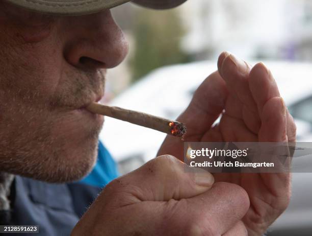 Man lights up a cannabis joint on April 03, 2024 in Bonn, Germany. Cannabis cultivation and consumption was permitted in Germany from April 1, 2024.