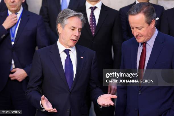 Secretary of State Antony Blinken talks with Britain's Foreign Secretary David Cameron as they stand for an official photograph during the North...