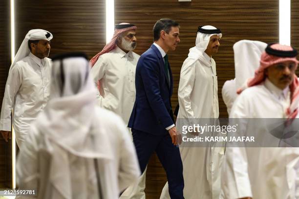 Spanish Prime Minister Pedro Sanchez and his Qatari counterpart Sheikh Mohammed bin Abdulrahman bin Jassim al-Thani leave the podium after giving a...