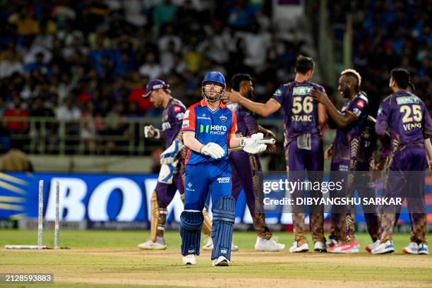 Kolkata Knight Riders' Mitchell Starc celebrates with teammates after taking the wicket of Delhi Capitals' David Warner during the Indian Premier...