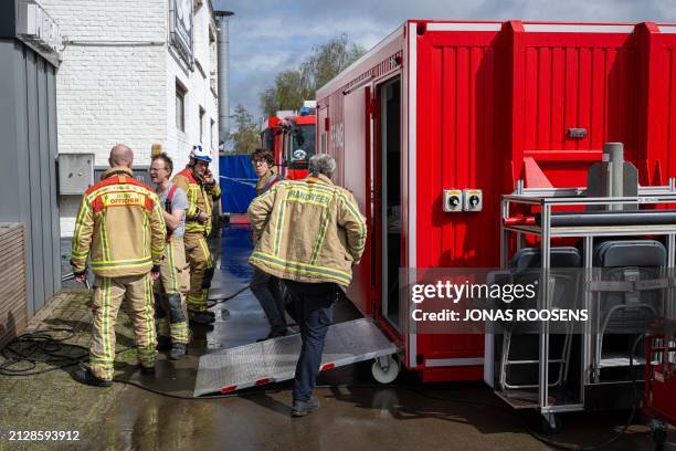 Firemen are seen at the site where three people were found dead in a drug lab in Poederlee near Lille, Antwerp province, Belgium, Wednesday 03 April...