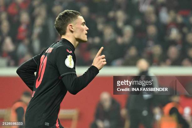 Bayer Leverkusen's German midfielder Florian Wirtz celebrates after scoring the team's fourth goal during the German Cup semi-final football match...