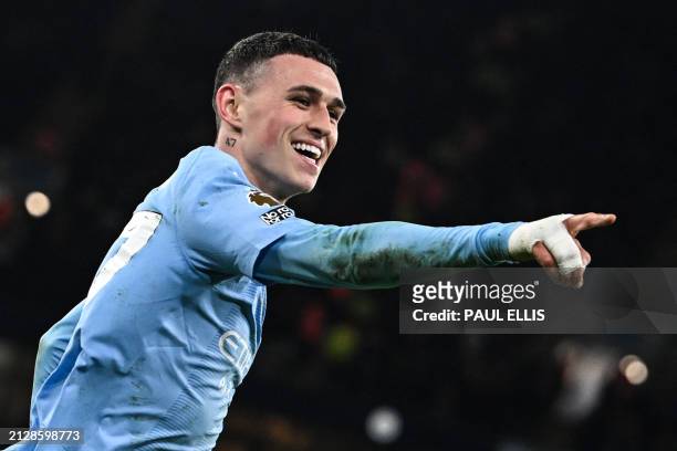 Manchester City's English midfielder Phil Foden celebrates after scoring his team thrid goal during the English Premier League football match between...