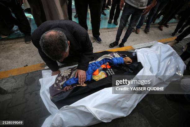 Mourners offer funeral prayers next to the body of Palestinian Issam Abu Taha, a worker from the World Central Kitchen , who was killed in an Israeli...