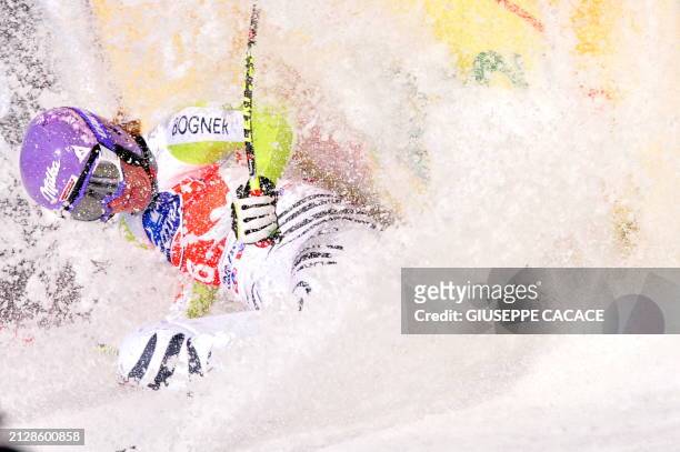 German Maria Riesch crashes in the finish area of the FIS World Cup Women's downhill event in Tarvisio on March 5, 2011. AFP PHOTO / GIUSEPPE CACACE