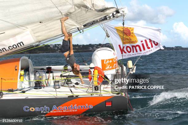 French skipper Julien Mabit celebrates his third place as he arrives at Pointe a Pitre, French west indies, after crossing the finish line of the...