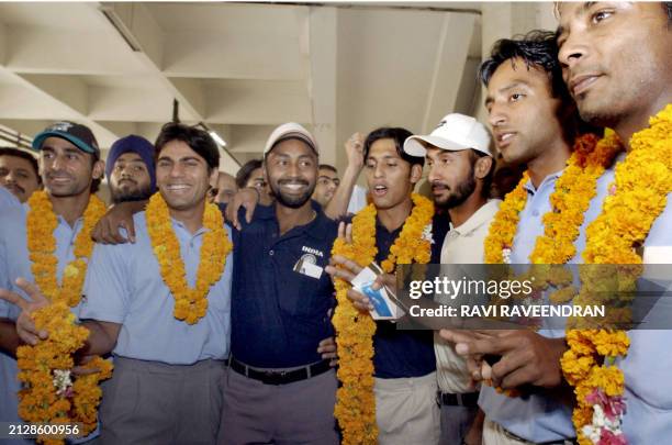 Indian hockey team arrive from Sydney at New Delhi's Indira Gandhi International airport, 10 June 2003. The Indian hockey team returned after winning...