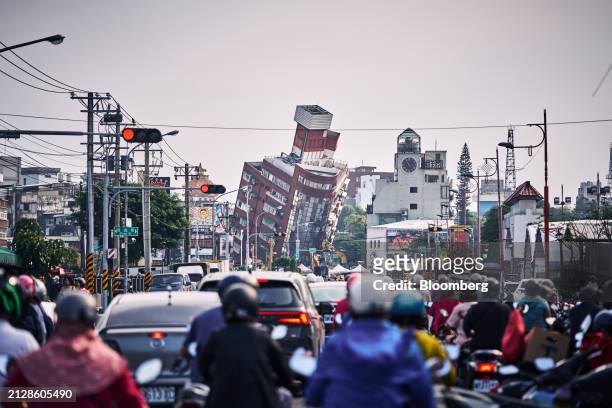 Traffic in front of a damaged building, far back, following an earthquake in Hualien, Taiwan, on Thursday, April 4, 2024. Taiwan's semiconductor...