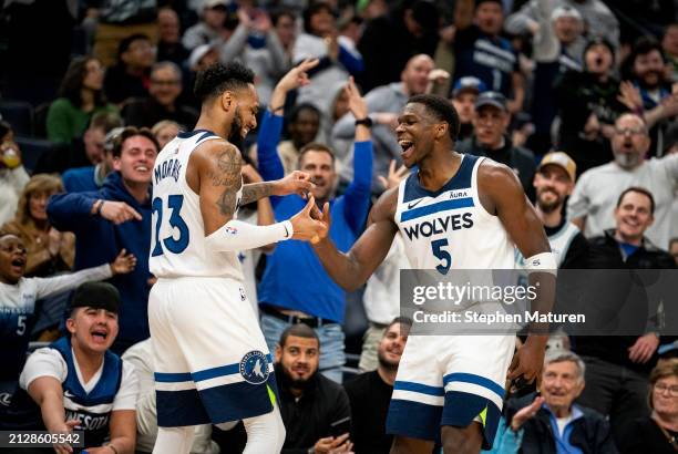 Monte Morris of the Minnesota Timberwolves celebrates with Anthony Edwards after making a three point shot to end of the third quarter of the game...