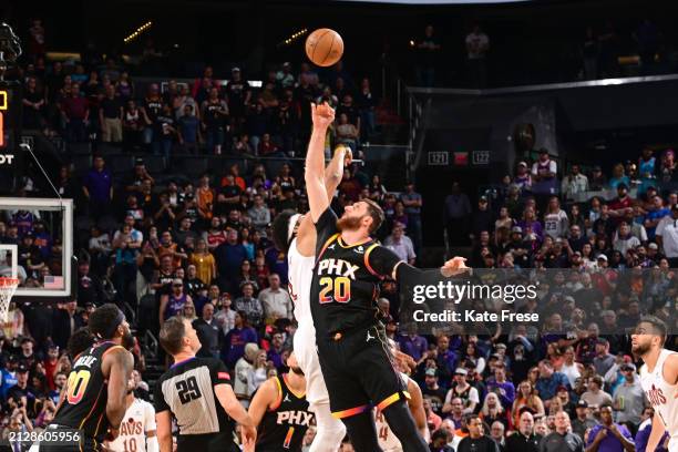 Jarrett Allen of the Cleveland Cavaliers and Jusuf Nurkic of the Phoenix Suns go for the opening tip-off during the game on April 3, 2024 at...