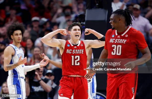 Michael O'Connell of the North Carolina State Wolfpack and DJ Burns Jr. #30 of the North Carolina State Wolfpack react after drawing a foul in the...