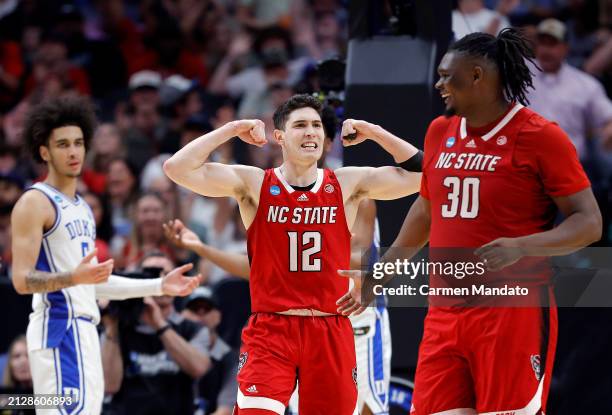 Michael O'Connell of the North Carolina State Wolfpack and DJ Burns Jr. #30 of the North Carolina State Wolfpack react after drawing a foul in the...