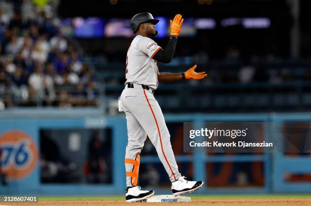 Jorge Soler of the San Francisco Giants celebrates at second base after hitting a double against pitcher Tyler Glasnow of the Los Angeles Dodgers...