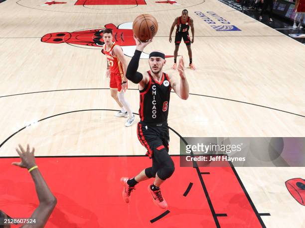 Alex Caruso of the Chicago Bulls shoots the ball during the game against the Atlanta Hawks on April 1, 2024 at United Center in Chicago, Illinois....
