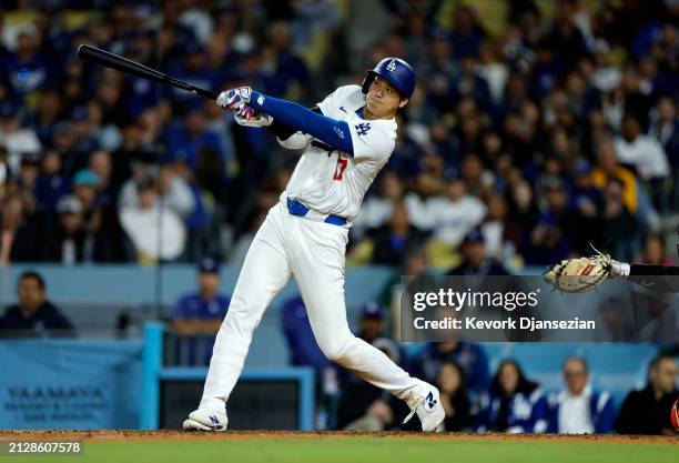 Shohei Ohtani of the Los Angeles Dodgers hits a solo home run during the seventh inning against the San Francisco Giants at Dodger Stadium on April...