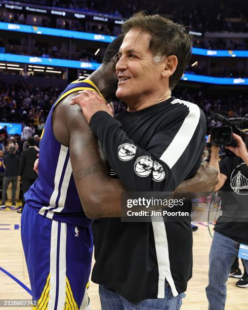 Draymond Green of the Golden State Warriors and minority owner Mark Cuban of the Dallas Mavericks embrace after the game on April 2, 2024 at Chase...
