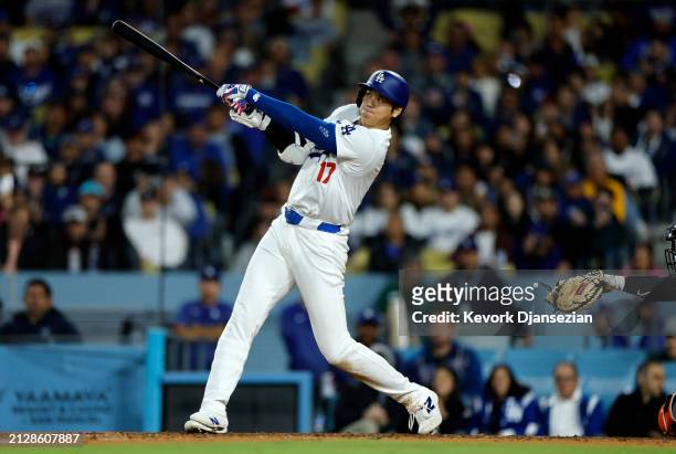 Shohei Ohtani of the Los Angeles Dodgers hits a solo home run during the seventh inning against the San Francisco Giants at Dodger Stadium on April...