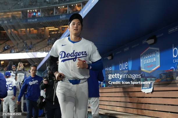 Los Angeles Dodgers designated hitter Shohei Ohtani jogs through the dugout following the game between the San Francisco Giants and the Los Angeles...