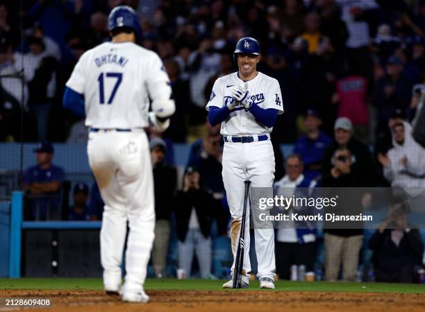 Shohei Ohtani of the Los Angeles Dodgers is congratulated by Freddie Freeman after hitting a solo home run during the seventh inning against the San...