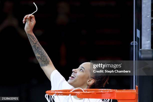 Aziaha James of the NC State Wolfpack celebrates after cutting down the net after defeating the Texas Longhorns 76-66 in the Elite 8 round of the...