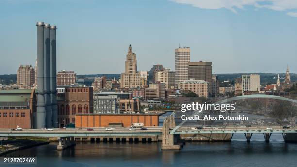 providence river bridge in front of providence downtown, rhode island. dominion energy manchester street station at the front. - providence rhode island stock pictures, royalty-free photos & images