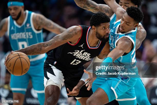 Brandon Miller of the Charlotte Hornets guards Paul George of the LA Clippers in the third quarter during their game at Spectrum Center on March 31,...