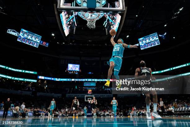 Tre Mann of the Charlotte Hornets dunks the ball in the third quarter during their game against the LA Clippers at Spectrum Center on March 31, 2024...