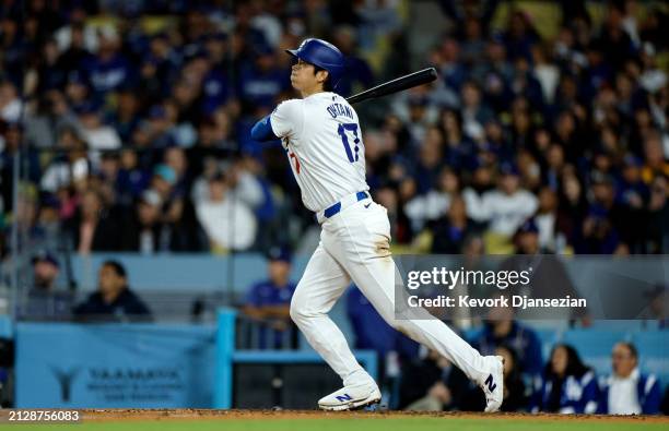 Shohei Ohtani of the Los Angeles Dodgers hits a solo home run during the seventh inning against the San Francisco Giants at Dodger Stadium on April...