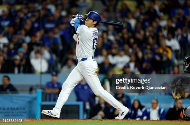 Shohei Ohtani of the Los Angeles Dodgers hits a solo home run during the seventh inning against the San Francisco Giants at Dodger Stadium on April...