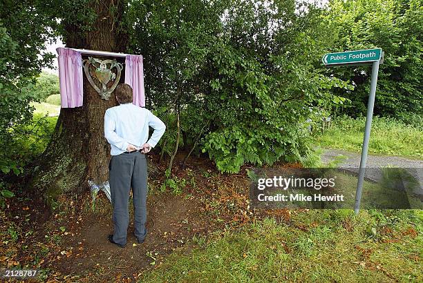 Member of the public pays his respects in front of a memorial plaque for Sarah Payne, which was unveiled July 1, 2003 in Pulborough, England. The...