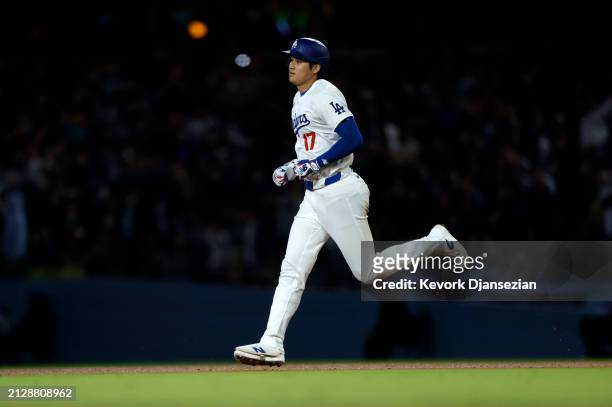 Shohei Ohtani of the Los Angeles Dodgers returns to the dugout after hitting a solo home run during the seventh inning against the San Francisco...