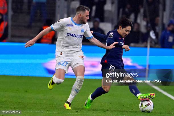 Lee Kang In of Paris Saint-Germain runs with the ball during the Ligue 1 Uber Eats match between Olympique de Marseille and Paris Saint-Germain at...