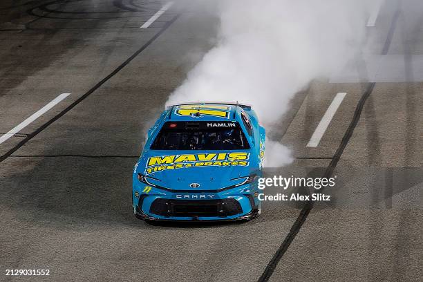 Denny Hamlin, driver of the Mavis Tires & Brakes Toyota, celebrates with a burnout after winning the NASCAR Cup Series Toyota Owners 400 at Richmond...