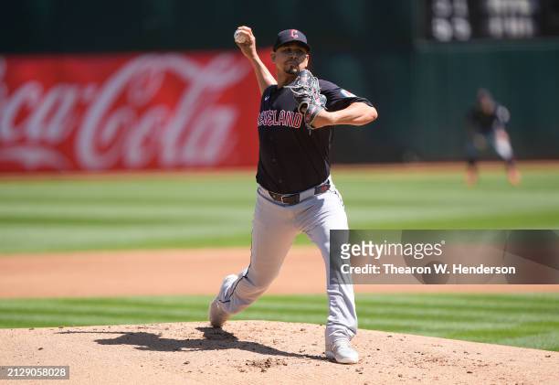 Carlos Carrasco of the Cleveland Guardians pitches against the Oakland Athletics in the bottom of the first inning on March 31, 2024 at the Oakland...