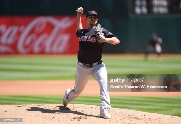 Carlos Carrasco of the Cleveland Guardians pitches against the Oakland Athletics in the bottom of the first inning on March 31, 2024 at the Oakland...