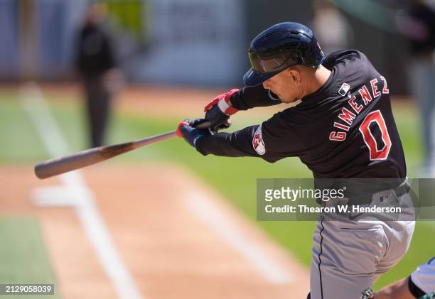 Andres Gimenez of the Cleveland Guardians bats against the Oakland Athletics in the top of the first inning on March 31, 2024 at the Oakland Coliseum...