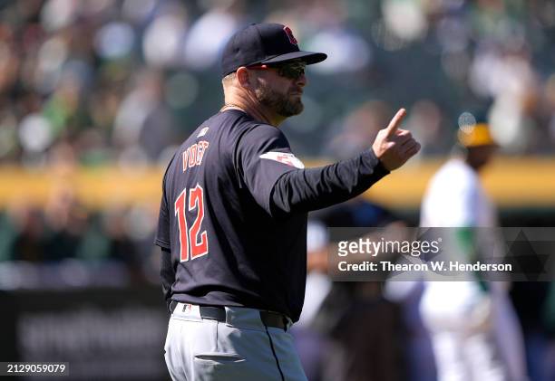 Manager Stephen Vogt of the Cleveland Guardians signals the bullpen to make a pitching change against the Oakland Athletics in the bottom of the...