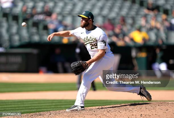 Austin Adams of the Oakland Athletics pitches against the Cleveland Guardians in the top of the eighth inning on March 31, 2024 at the Oakland...