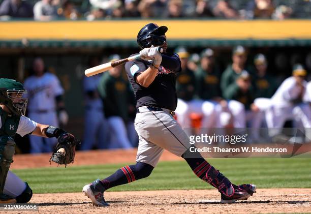 Josh Naylor of the Cleveland Guardians hits an rbi single scoring Jose Ramirez against the Oakland Athletics in the top of the eighth inning on March...