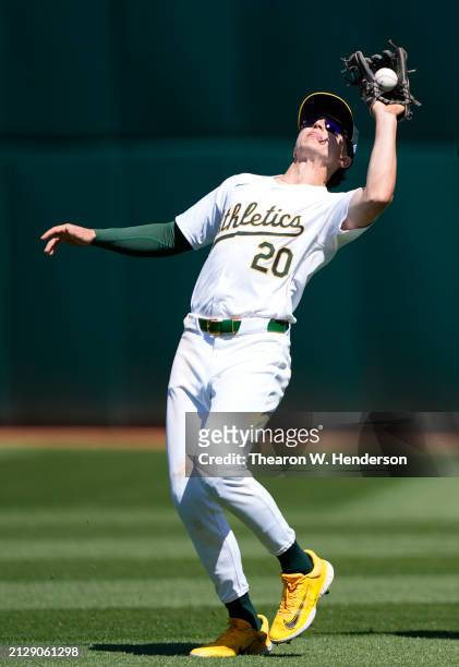 Zack Gelof of the Oakland Athletics catches a pop-up hit by Gabriel Arias of the Cleveland Guardians in the top of the fifth inning on March 31, 2024...