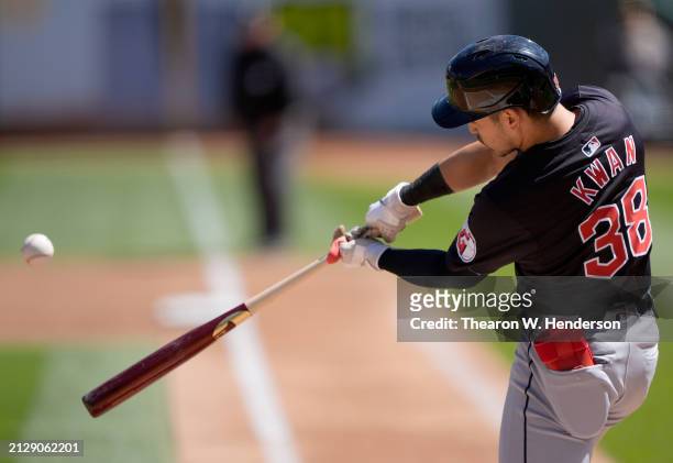 Steven Kwan of the Cleveland Guardians bats against the Oakland Athletics in the top of the first inning on March 31, 2024 at the Oakland Coliseum in...
