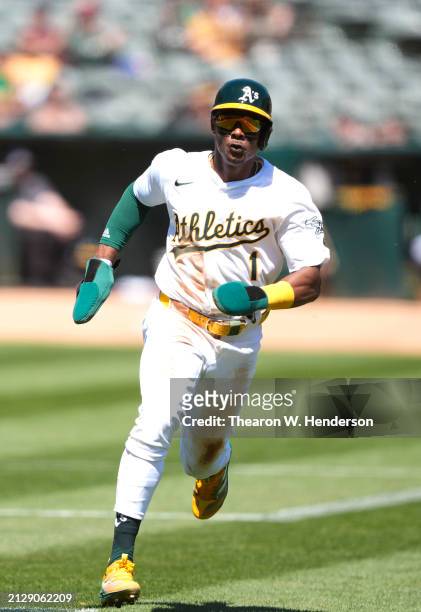 Esteury Ruiz of the Oakland Athletics rounds third base to score against the Cleveland Guardians in the bottom of the first inning on March 31, 2024...