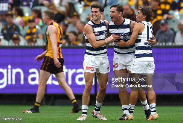 Tom Hawkins of the Cats is congratulated by team mates after kicking a goal during the round three AFL match between Hawthorn Hawks and Geelong Cats...