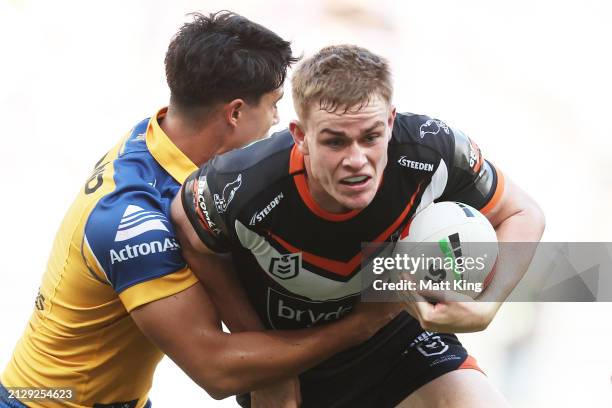 Lachlan Galvin of the Tigers is tackled during the round four NRL match between Parramatta Eels and Wests Tigers at CommBank Stadium, on April 01 in...