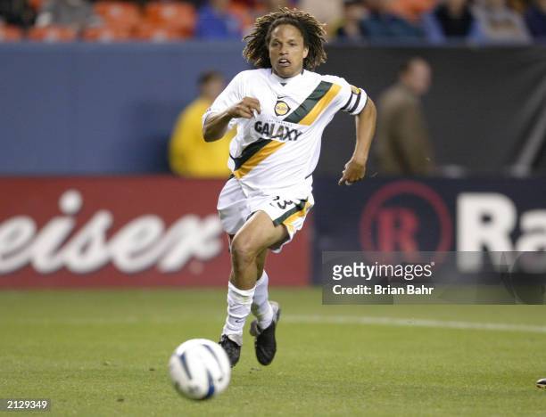 Midfielder Cobi Jones of the Los Angeles Galaxy dribbles the ball against the Colorado Rapids during the MLS game at Invesco Field at Mile High on...