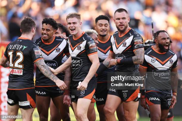 Lachlan Galvin of the Tigers celebrates victory with team mates after the round four NRL match between Parramatta Eels and Wests Tigers at CommBank...