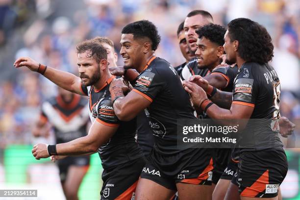 Aidan Sezer of the Tigers celebrates with team mates after kicking a field goal during the round four NRL match between Parramatta Eels and Wests...